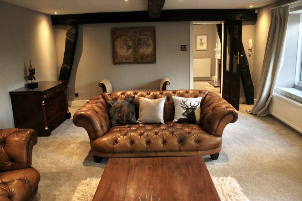 Luxury living room with sofa and fireplace at Habberjam Farm
