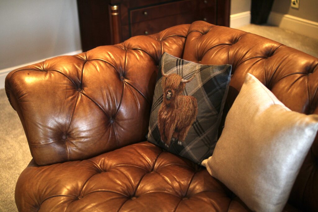 Leather Chesterfield sofa detail in the living room at Habberjam Farm