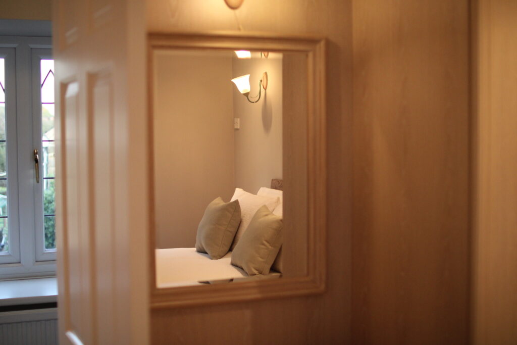 Farmhouse bedroom wardrobe and mirror detail at Habberjam Farm