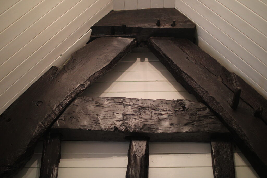 Roof-level bedroom with original timber beams at Habberjam Farm