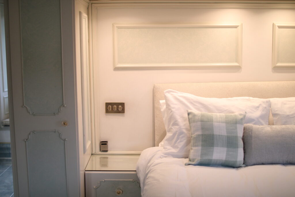 Traditional farmhouse bedroom with classic headboard at Habberjam Farm