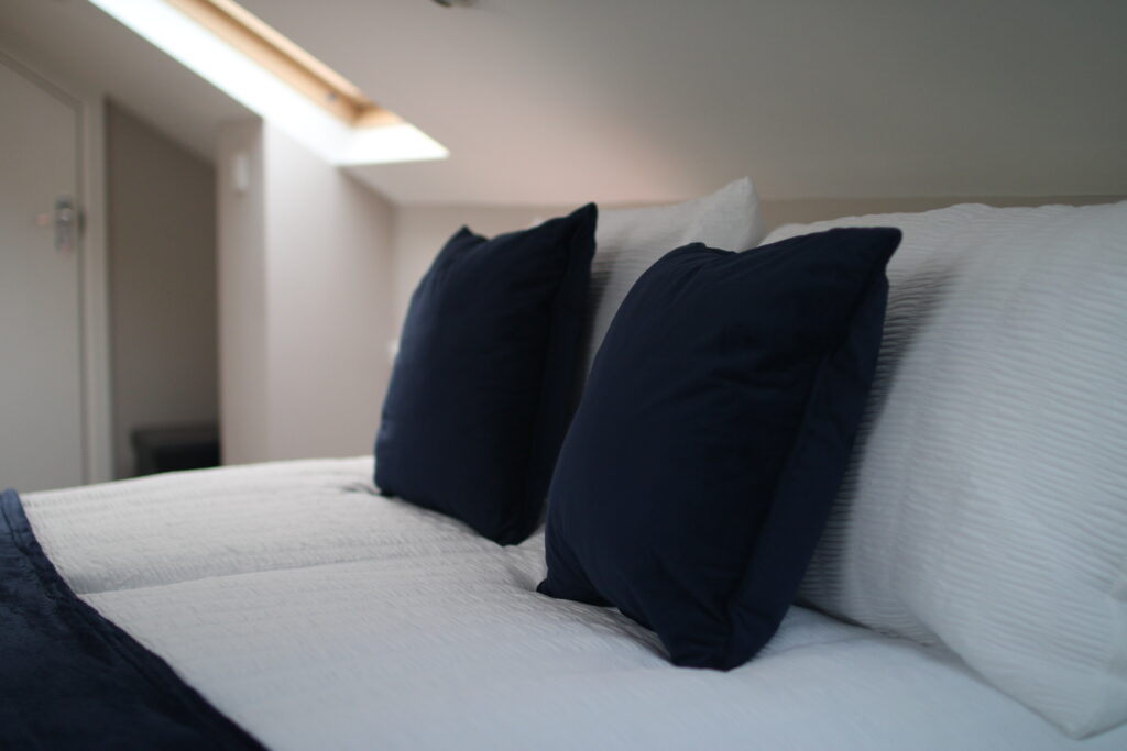 Comfortable double bedroom with crisp white bedding at Habberjam Farm