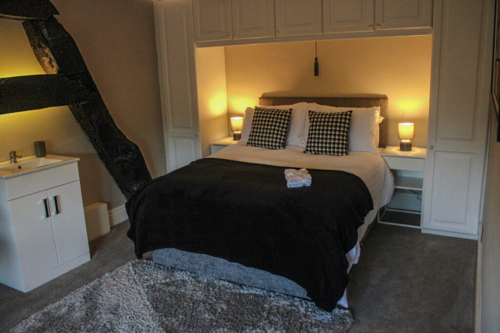 Cosy bedroom lighting and furnishings at Habberjam Farm